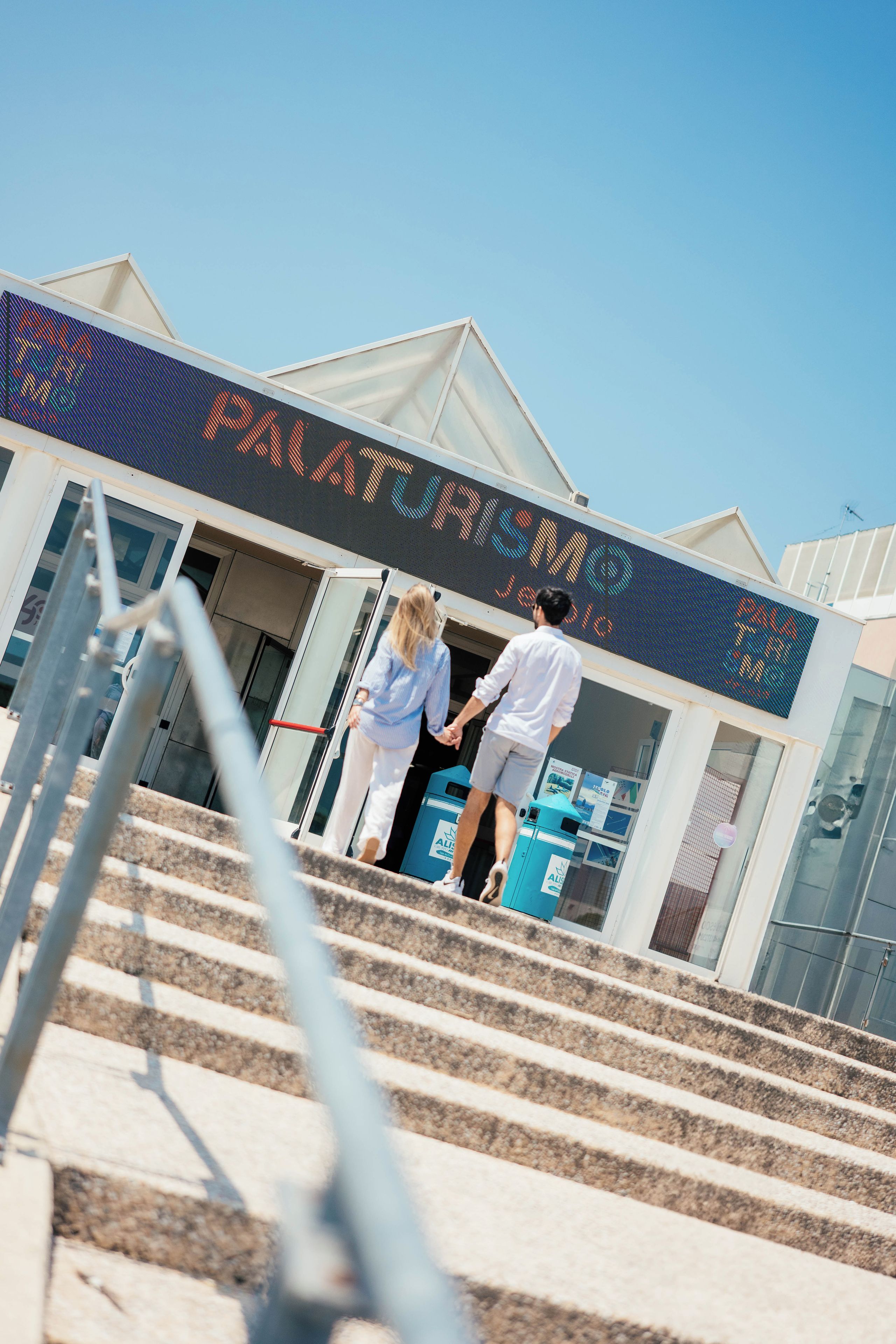 A hotel entrance with a digital sign displaying the name 'PALATINO'.