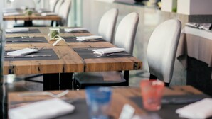 A conference room with long tables, chairs, and a modern interior design. - Hotel Colombo (Jesolo)