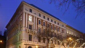 A large, historic building with classical architecture, featuring multiple windows and a prominent entrance. - Hotel Moments Budapest (Budapest)