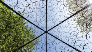 A geometric metal structure with intricate designs, possibly part of a building's architecture. - Statham Lodge Hotel (Lymm)