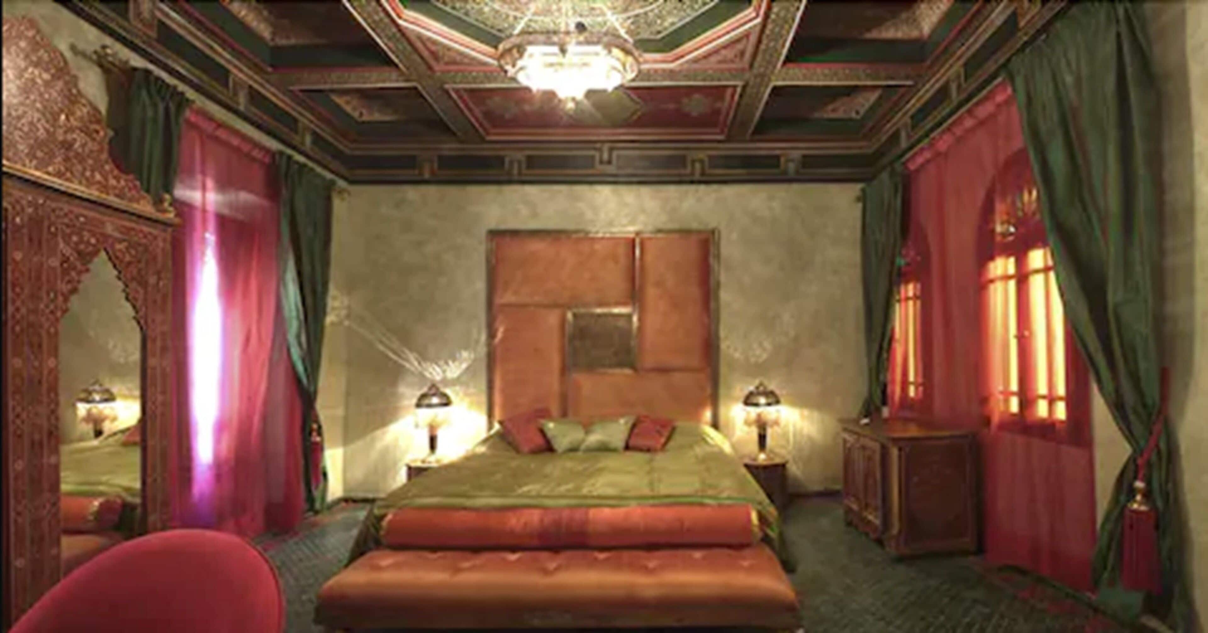 Une chambre spacieuse avec un grand lit, un plafond décoré et un décor classique.