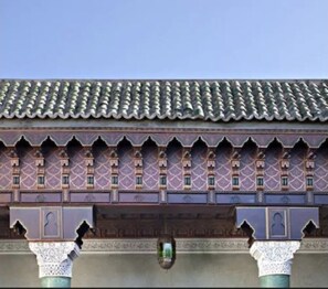 A building with a tiled roof and ornate architectural details.