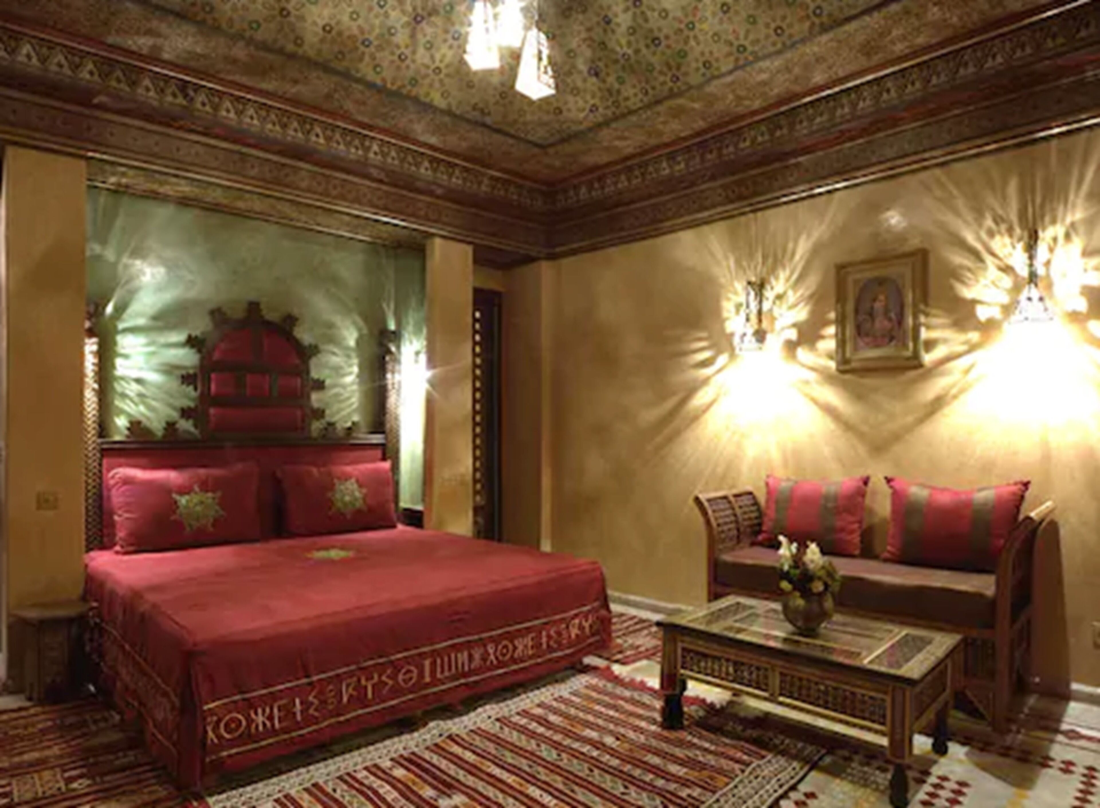 A traditional room with a large bed, a sofa, and a coffee table.