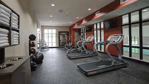 A gym with treadmills, exercise balls, and a wall-mounted TV. - Hampton Inn & Suites Ardmore (Ardmore)