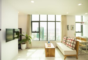 Romantic Apartment, 1 Bedroom, Partial Ocean View, Beachside | Living area | Flat-screen TV