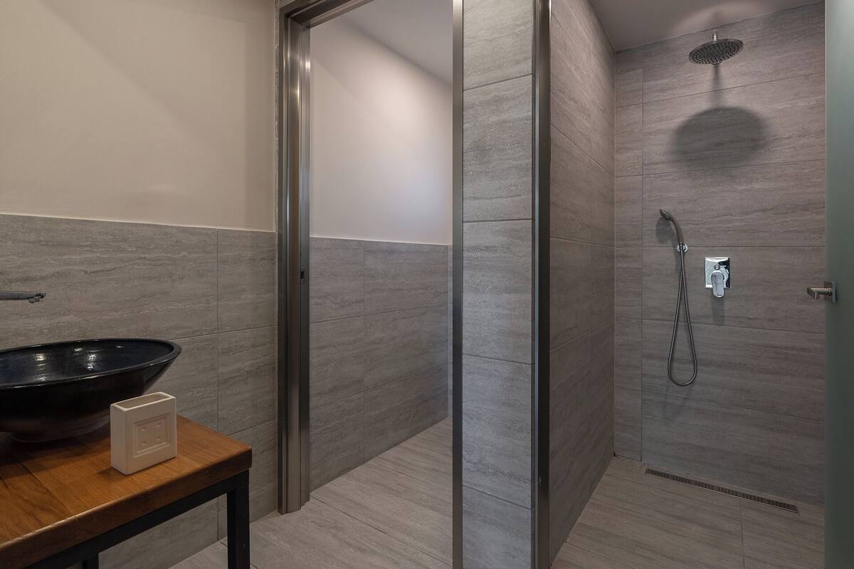 junior suite, 1 bedroom, garden view | bathroom | shower, free toiletries, hair dryer, towels