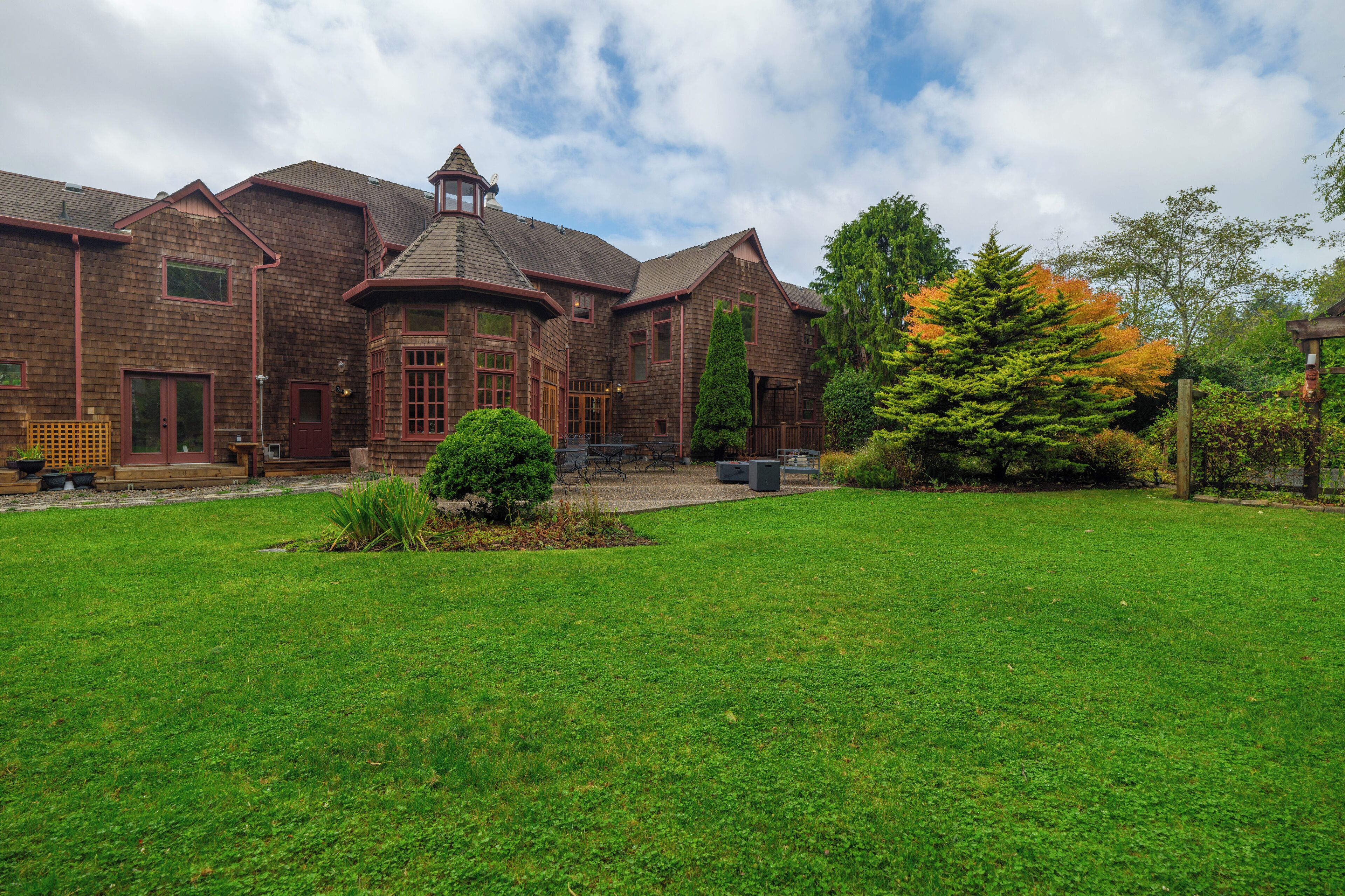 A large brick building with a prominent turret and multiple windows.