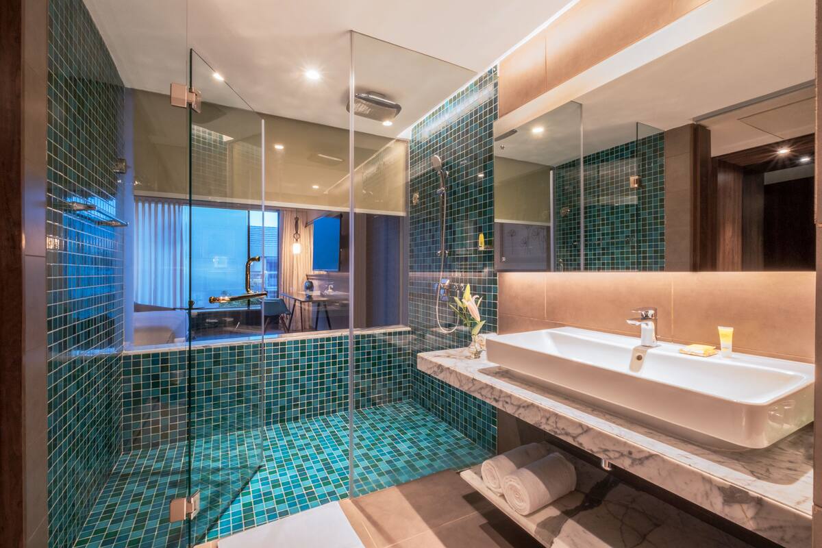 1 bedroom suite with 1 king bed and sofabed | bathroom | free toiletries, hair dryer, bathrobes, slippers