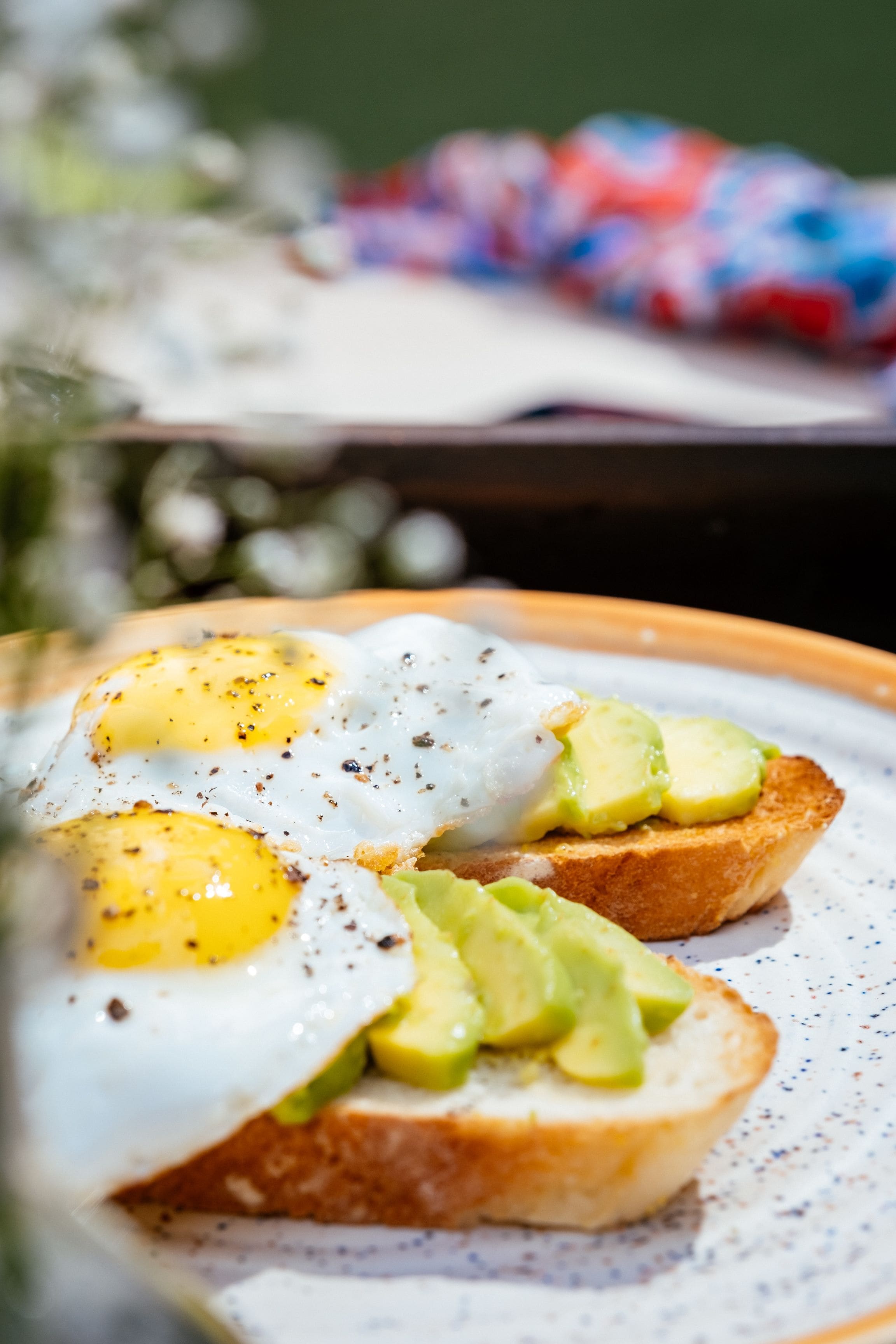 A breakfast dish with eggs and avocado on toast.