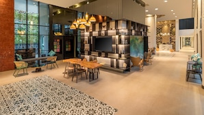 A modern interior with a central seating area, a large TV, and a decorative wall.