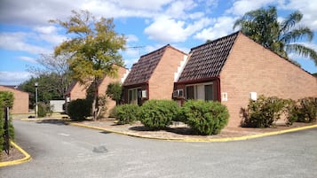 A row of brick buildings with pitched roofs, likely a residential or hotel complex.