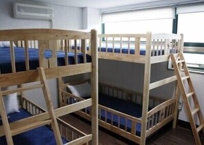 A bunk bed room with a ladder, a window, and an air conditioning unit. - The Style Capsule Guesthouse - Hostel (Daegu)