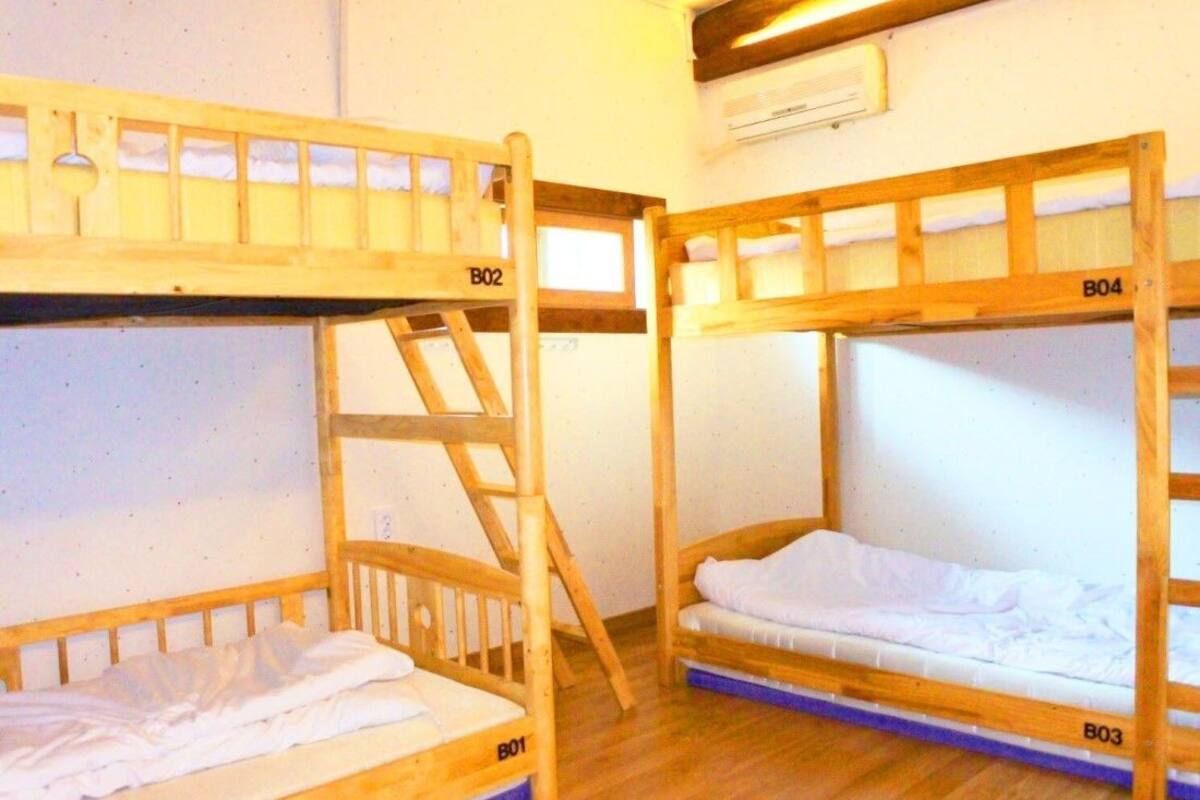 Two bunk beds labeled B01 and B02, with a ladder attached to B02.