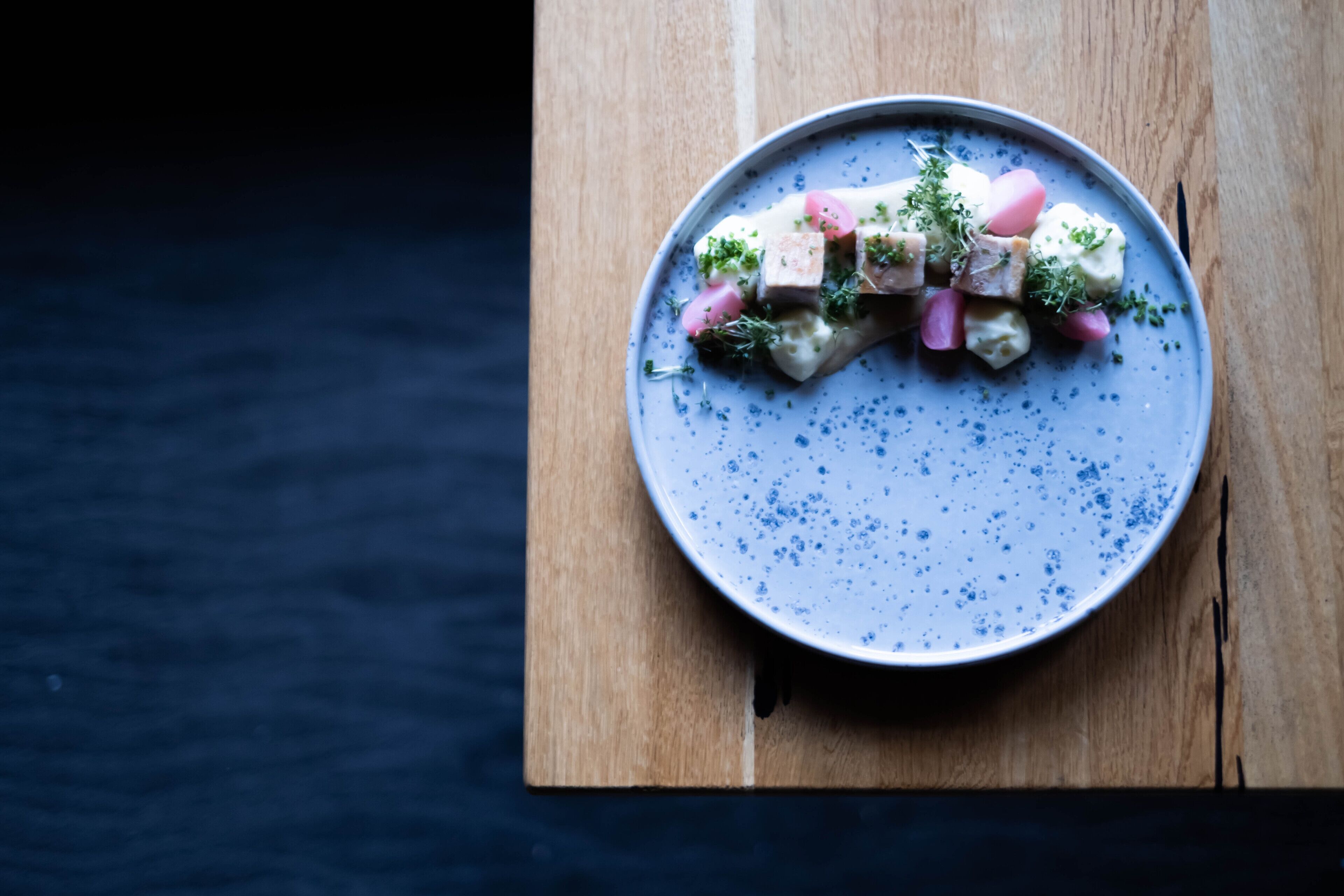 A plate of food on a wooden board.