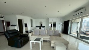 Suite, Kitchen, Ocean View | Living area | 50-inch flat-screen TV with cable channels, TV - View Talay 6 Condominium by Honey (Pattaya)