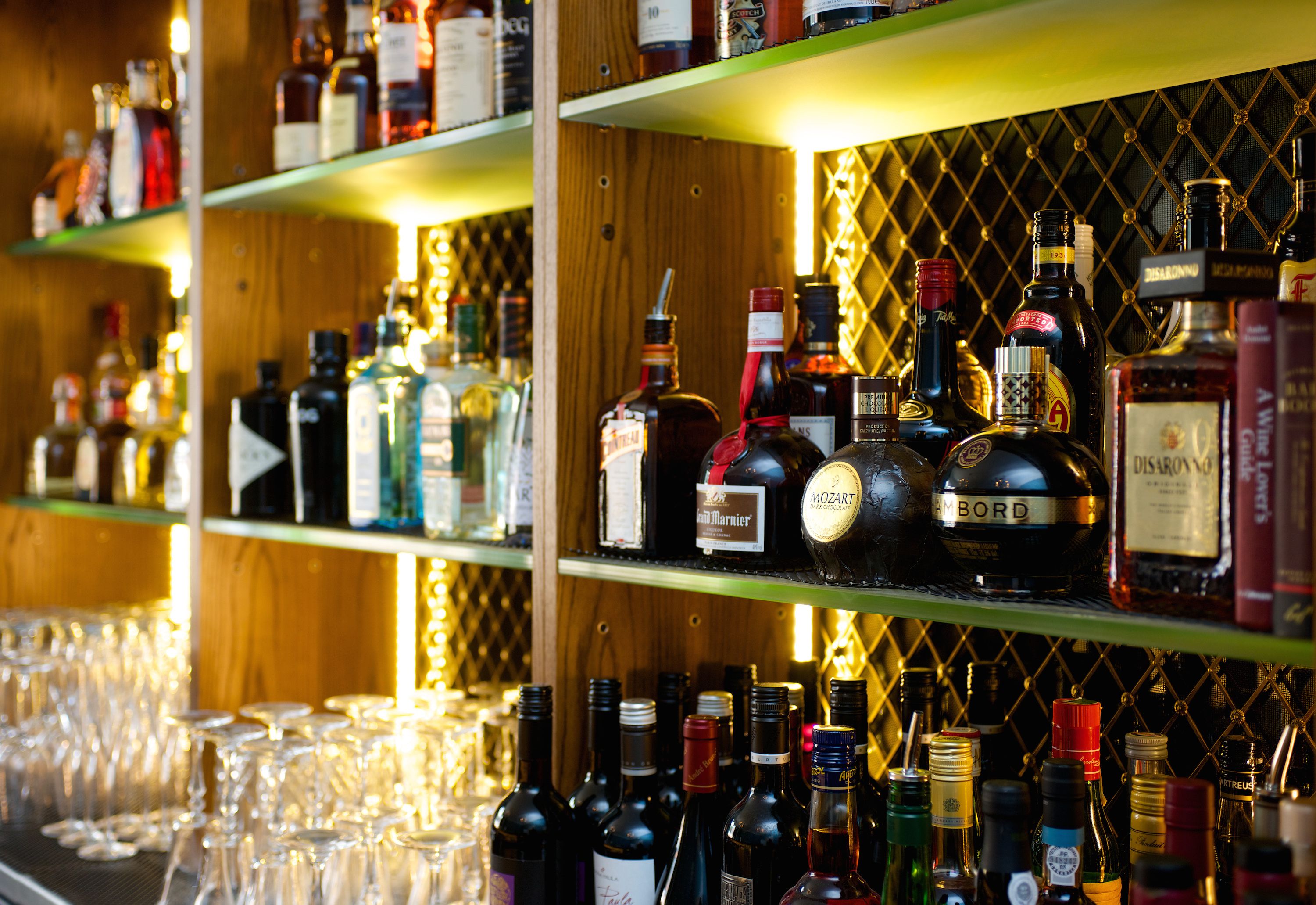 Shelves stocked with various liquor bottles and glasses.