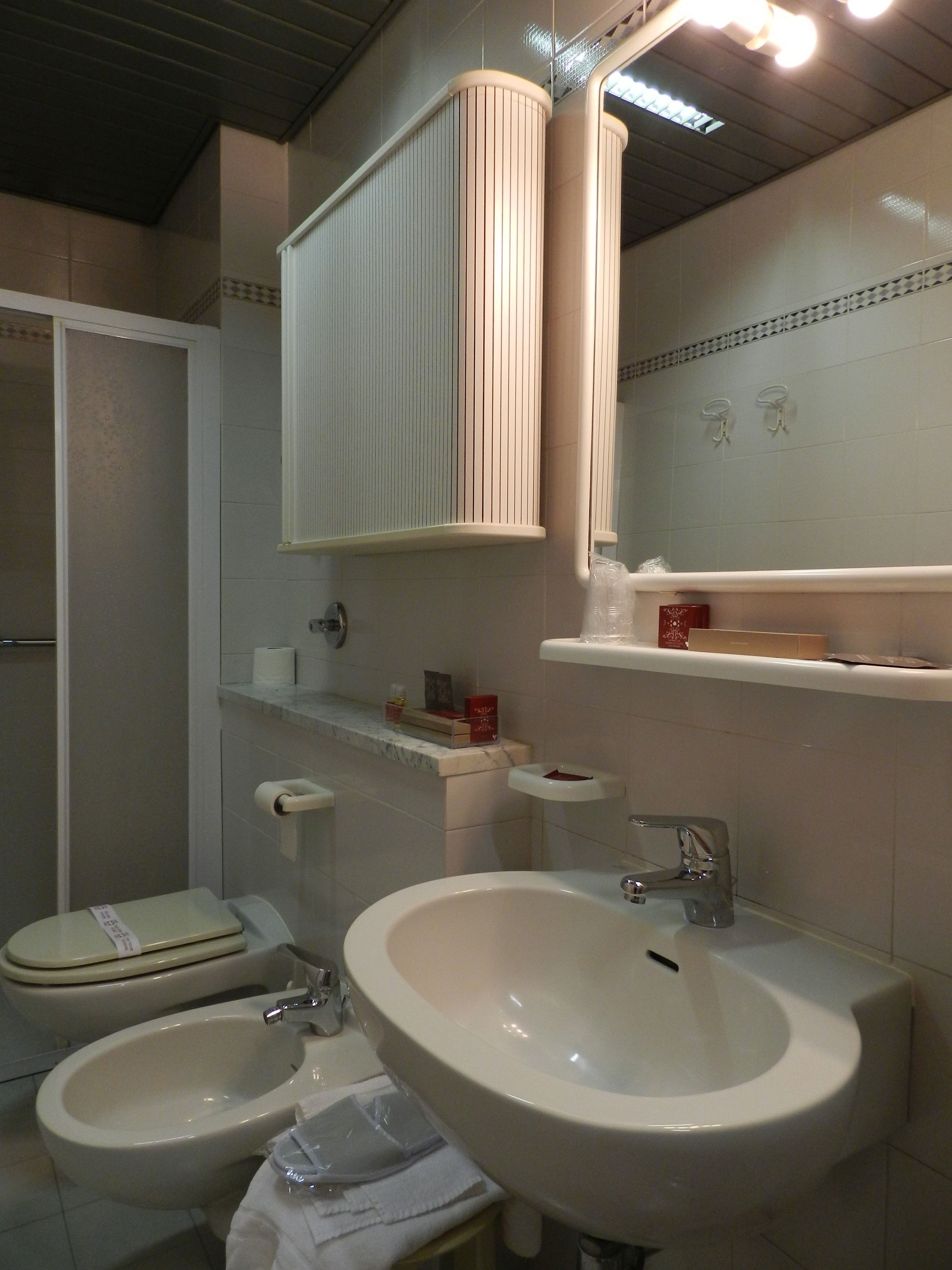 A bathroom with two sinks, a toilet, and a shower.