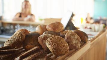 A variety of breads displayed on a wooden counter.