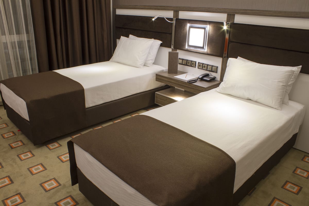 Deluxe Triple Room | Minibar, in-room safe, desk, iron/ironing board (on request)