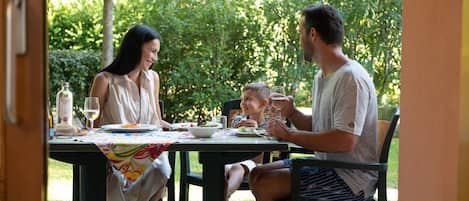 An outdoor dining area with a table set for four people.
