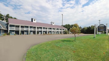 A building with a large parking lot and a sign for Yankee Clipper Inn.