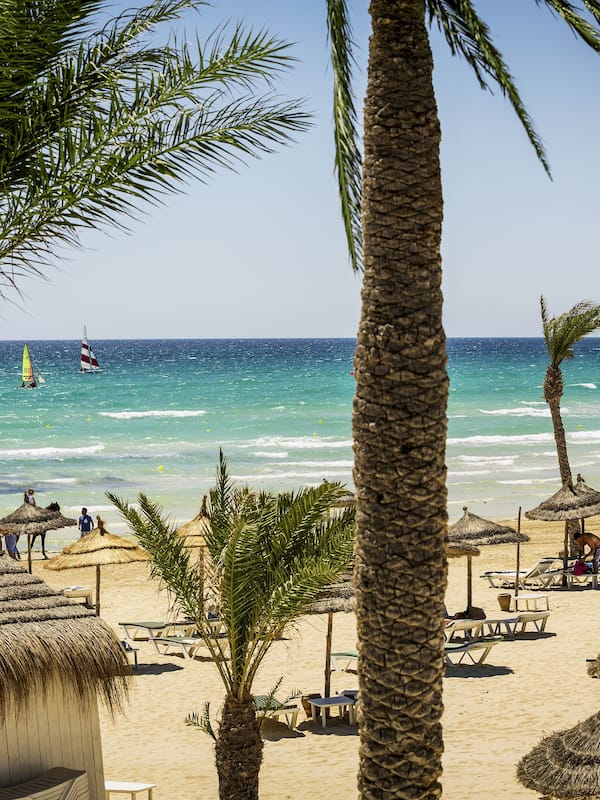 On the beach, beach umbrellas, beach towels, beach volleyball