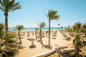 On the beach, beach umbrellas, beach towels, beach volleyball