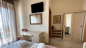 A hotel room with a bed, a desk, a television, and a wardrobe. - Hotel Franca (Cervia)