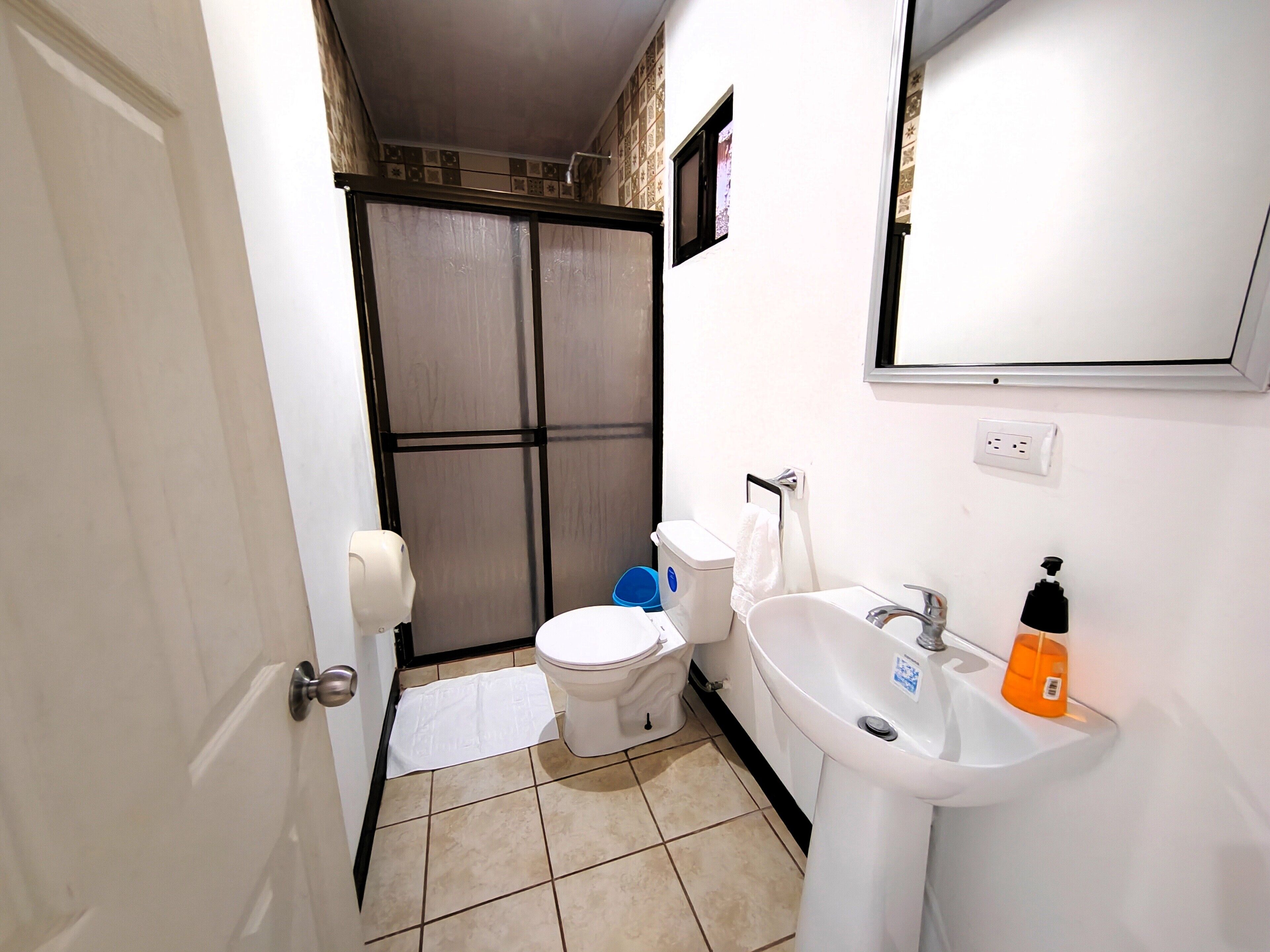 deluxe room | bathroom | shower, rainfall showerhead, free toiletries, hair dryer