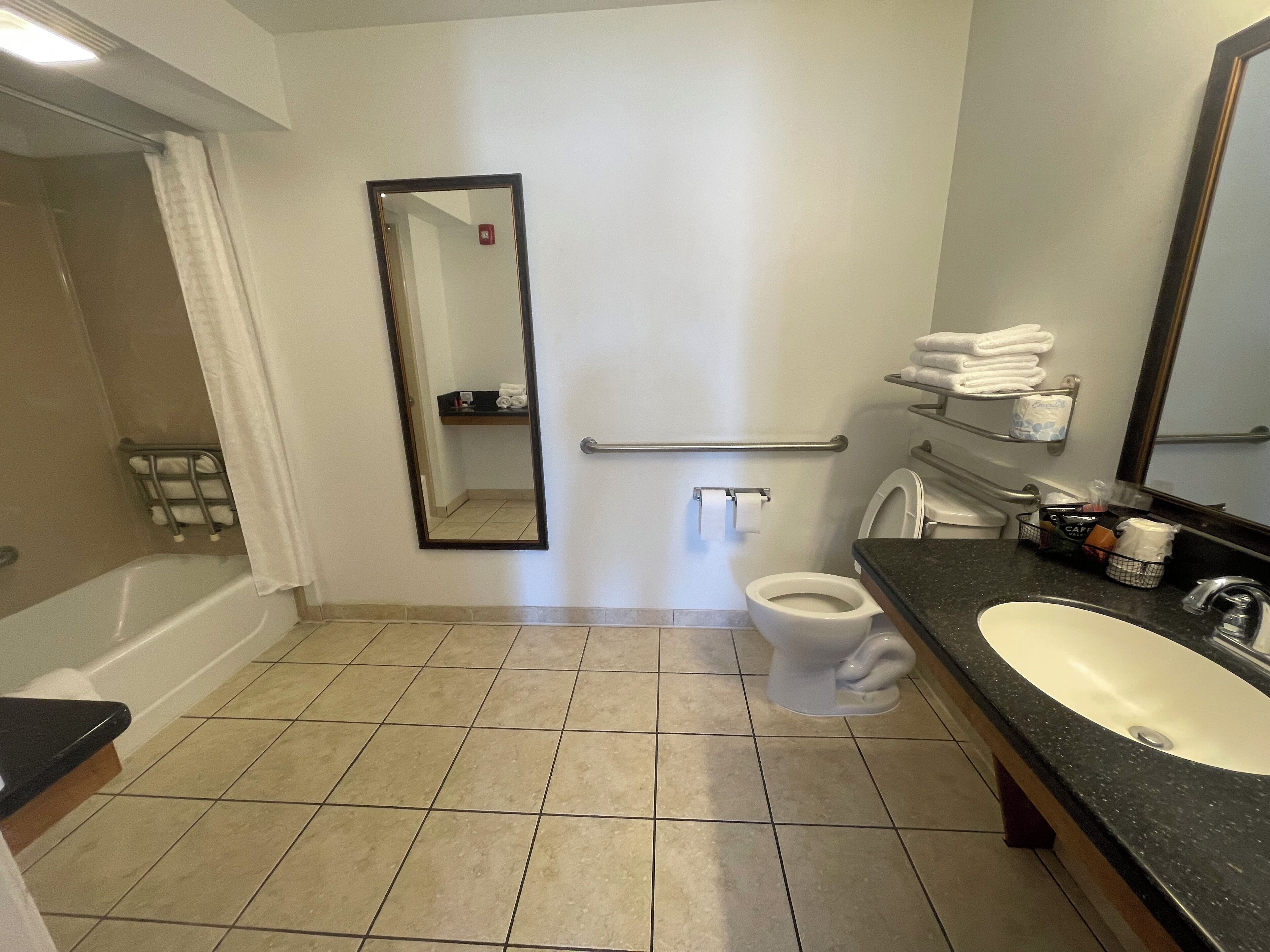 A bathroom with a bathtub, toilet, and sink.