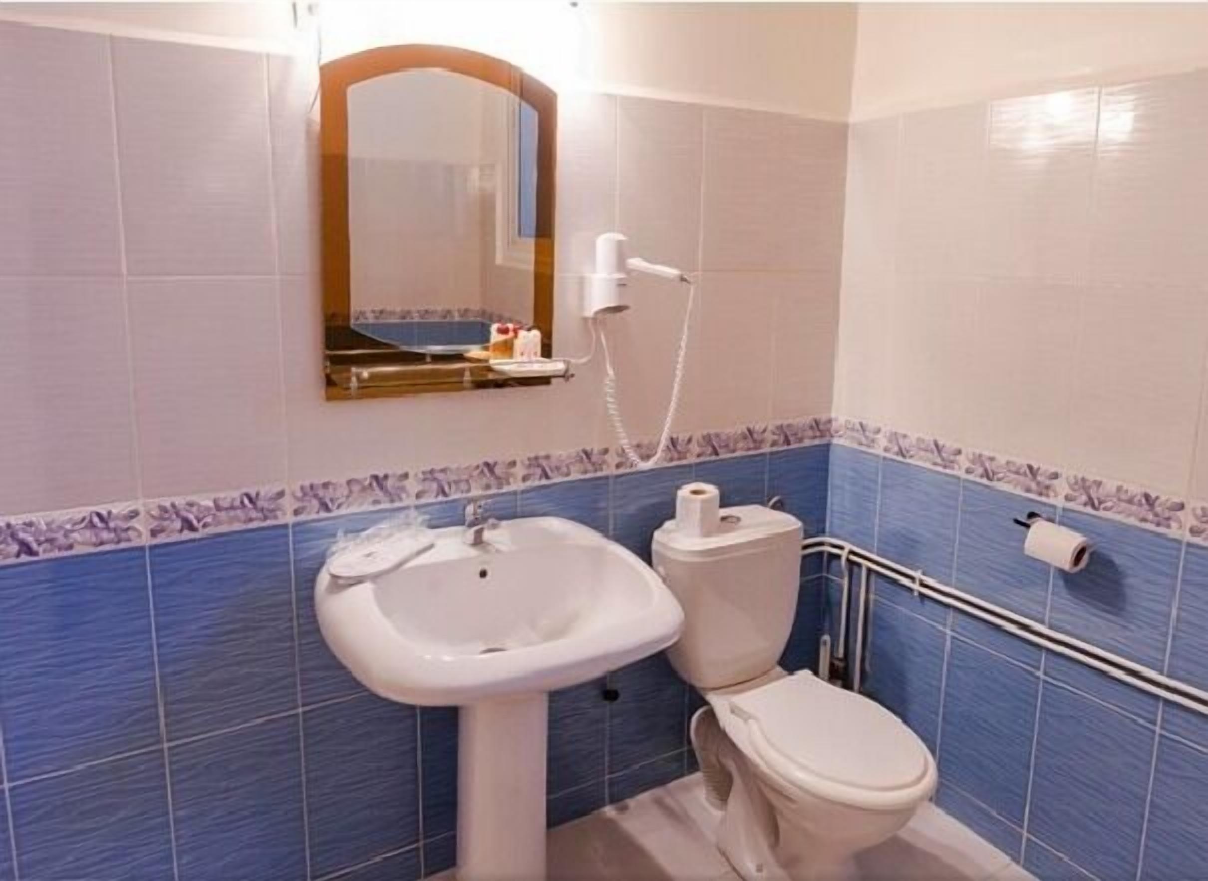 A bathroom with a sink, toilet, and shower.
