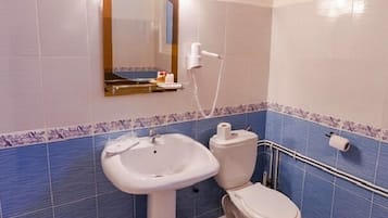 A bathroom with a sink, toilet, and shower.