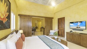 A hotel room with a large bed, a television, wooden furniture, and a painting on the wall. - EQC Hotel 60 (Région Test)