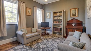 A living room with two sofas, a television, a bookshelf, and a fireplace. - White's Corner (Bothwell)