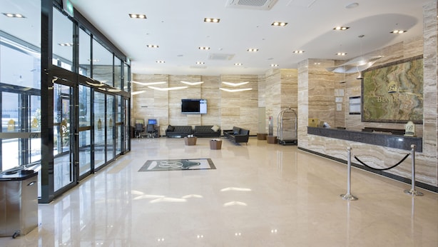 A spacious lobby with a reception desk, seating area, and a large digital screen. - Benikea Hotel Haeundae (Busan)