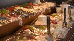 A buffet with various food items and utensils.