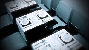 A dining area with tables set for four, each with plates, cutlery, and glasses. - Andrea Doria Resort (Rome)