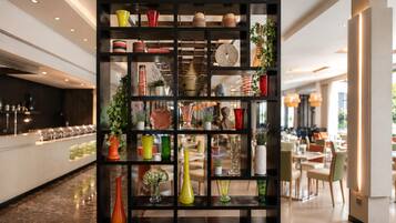 A modern interior with a black shelving unit displaying various decorative items.