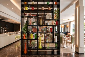 A modern interior with a black shelving unit displaying various decorative items. - DoubleTree by Hilton Nairobi Hurlingham (Nairobi)