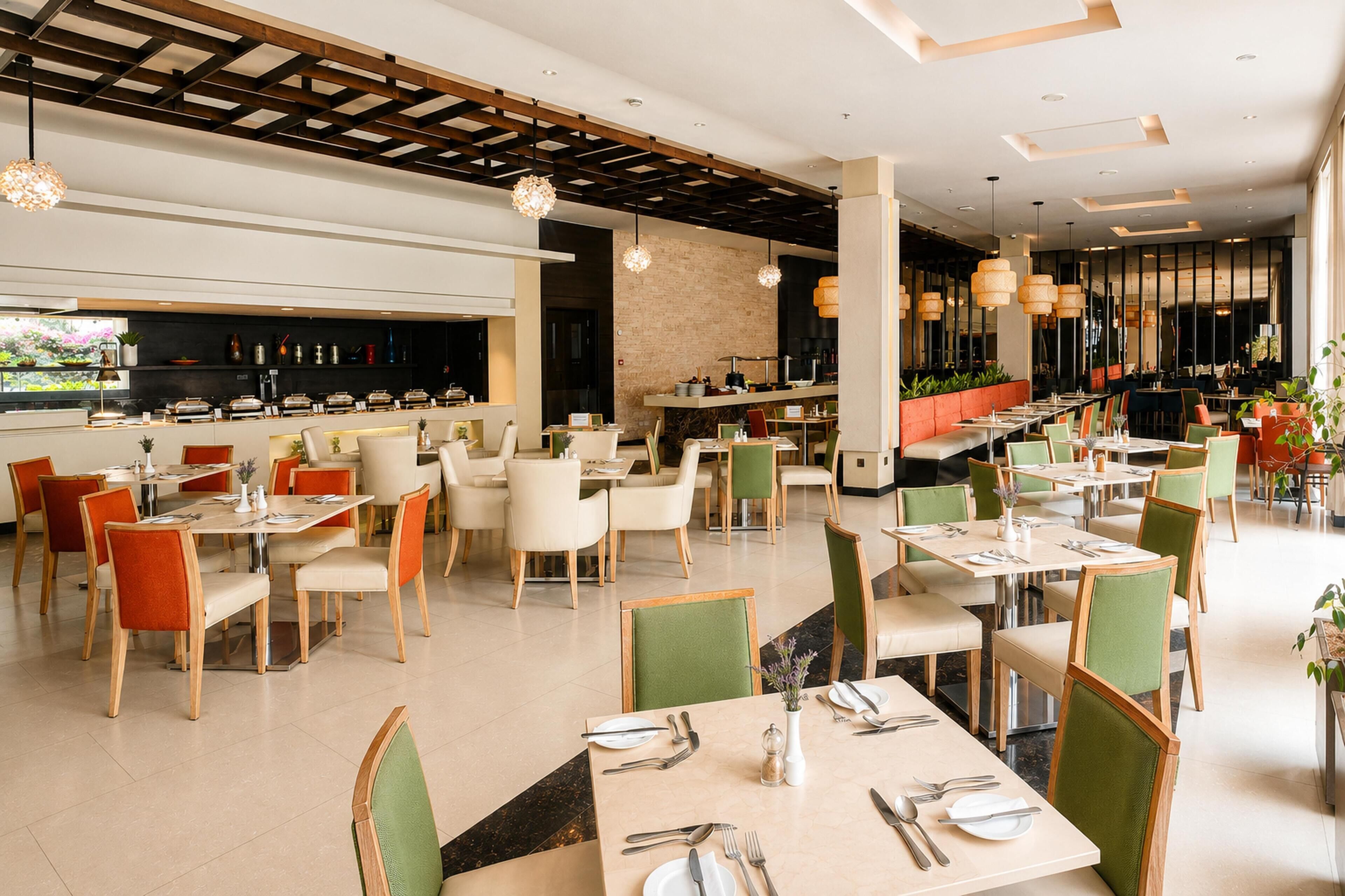 A spacious restaurant with multiple dining areas, a bar, and a variety of seating options.