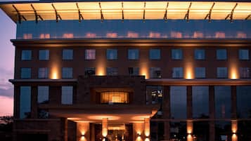 A hotel with a modern facade, multiple floors, and a prominent entrance with lighting.