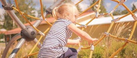 A child playing on a rope net structure.