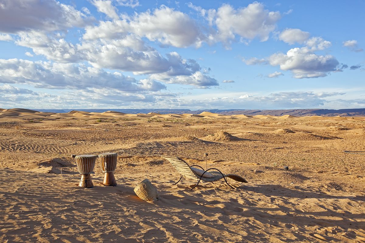 A desert landscape with sand dunes and a clear sky.