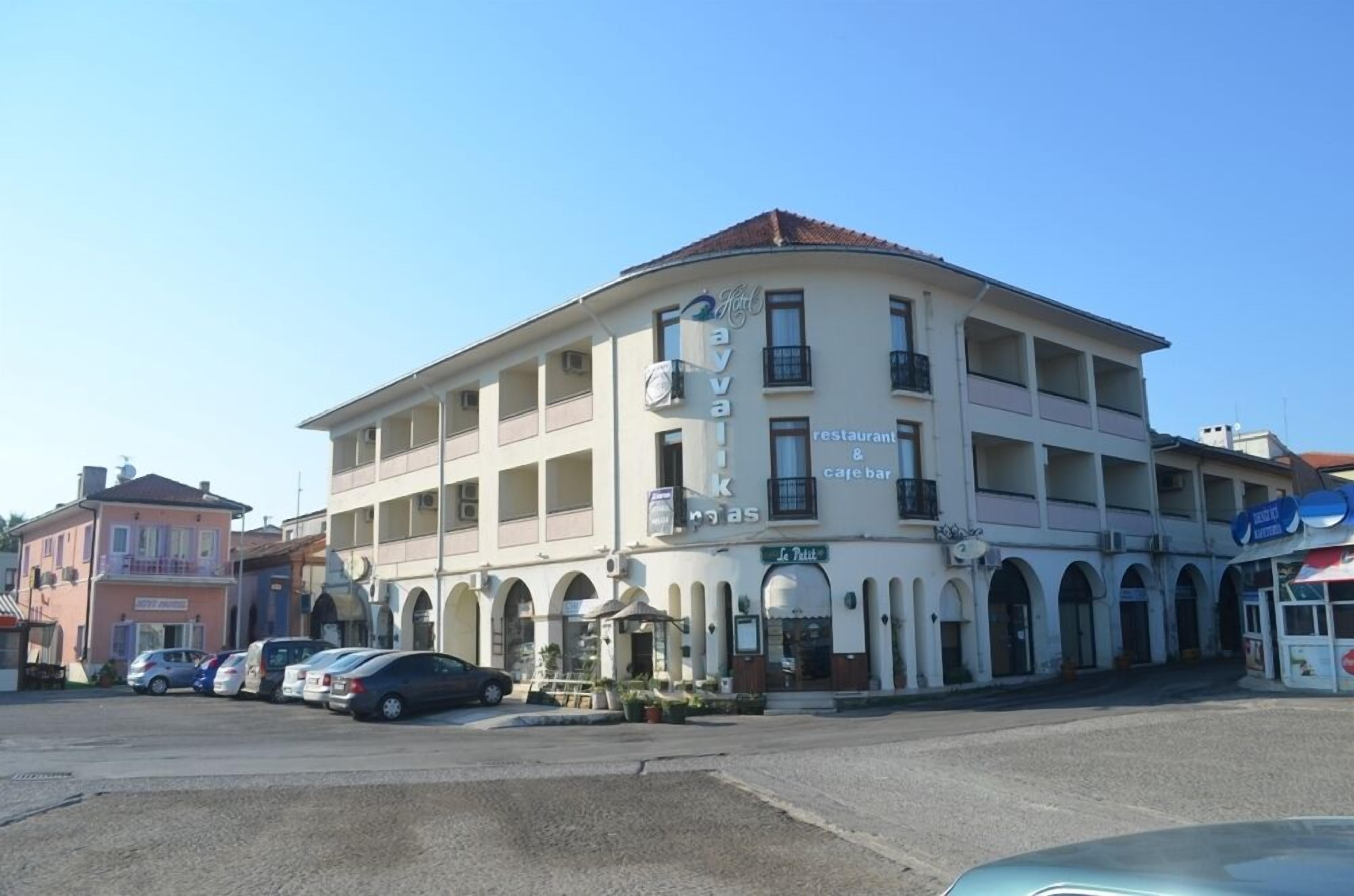 A multi-story building with a cafe and restaurant on the ground floor.