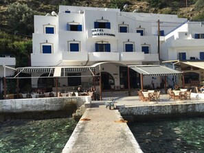 A white building with blue shutters and a sign reading "HOTEL DEKALOKIANS". - Daskalogiannis Hotel (Sfakia)