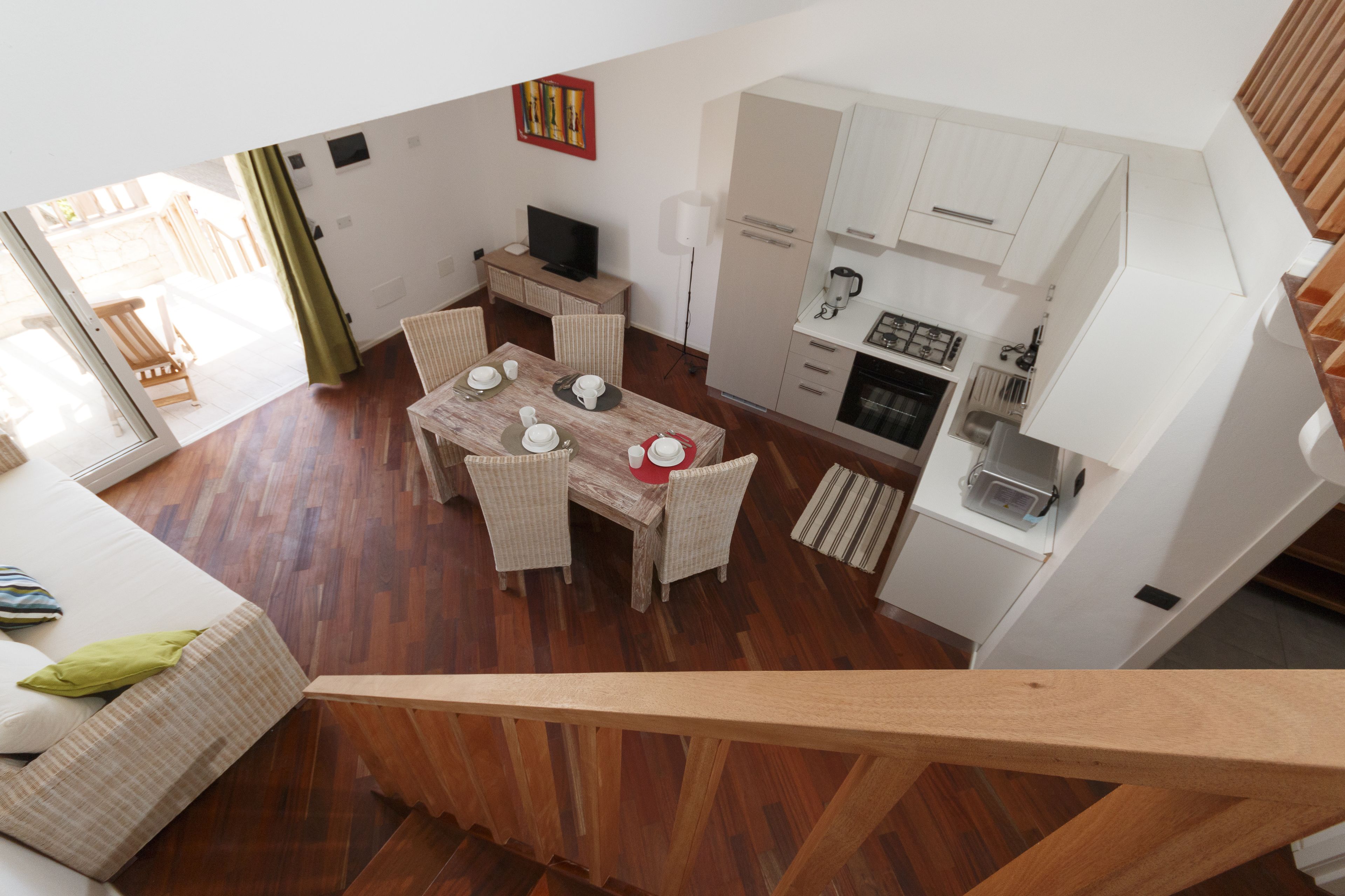 A modern apartment with a dining area, kitchen, and living space.