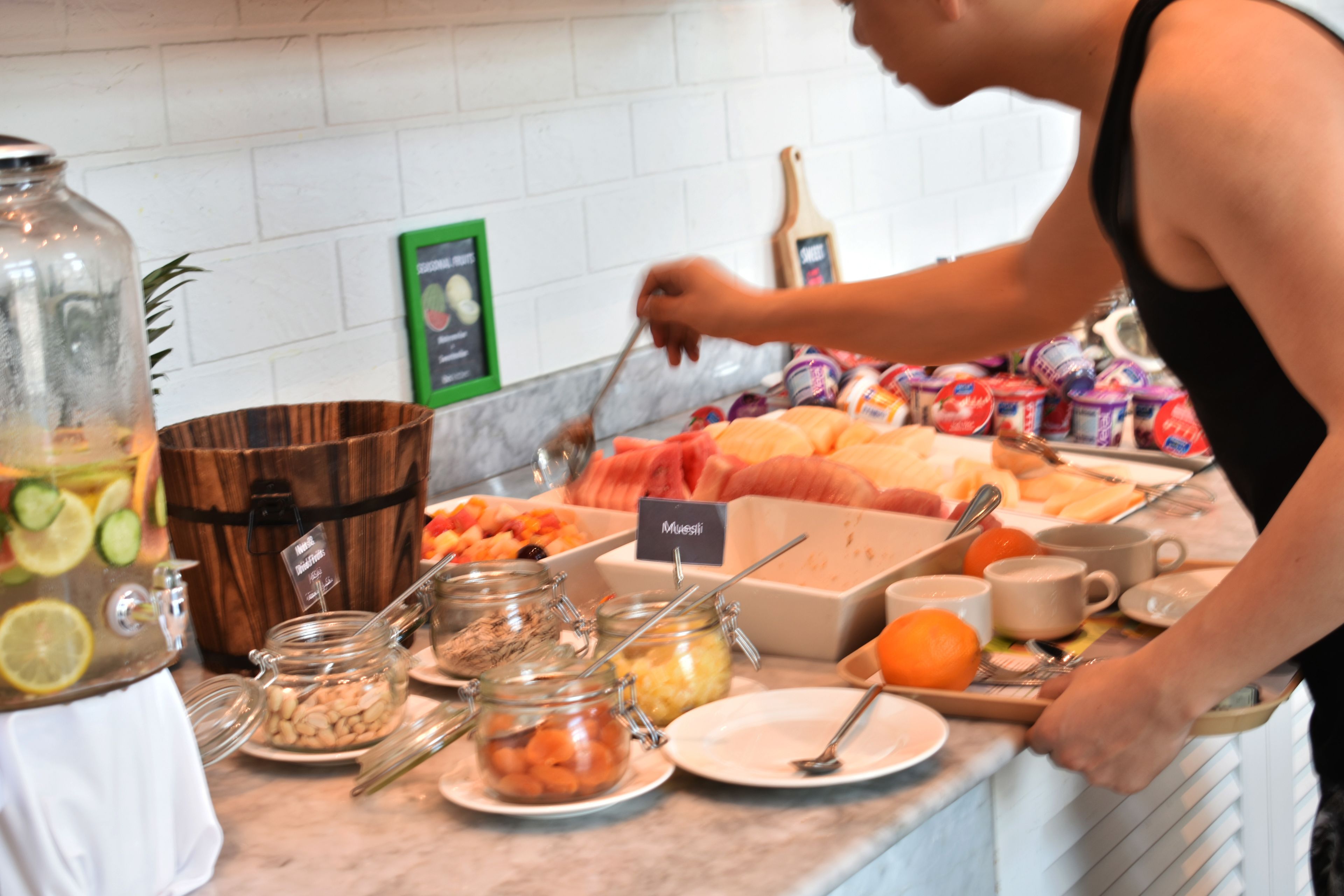 A buffet setup with various food items and condiments.