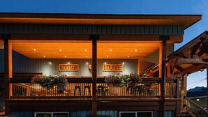 A modern building with a wooden facade, a balcony with railings, and signs reading "KODIAK" and "LOUNGE".