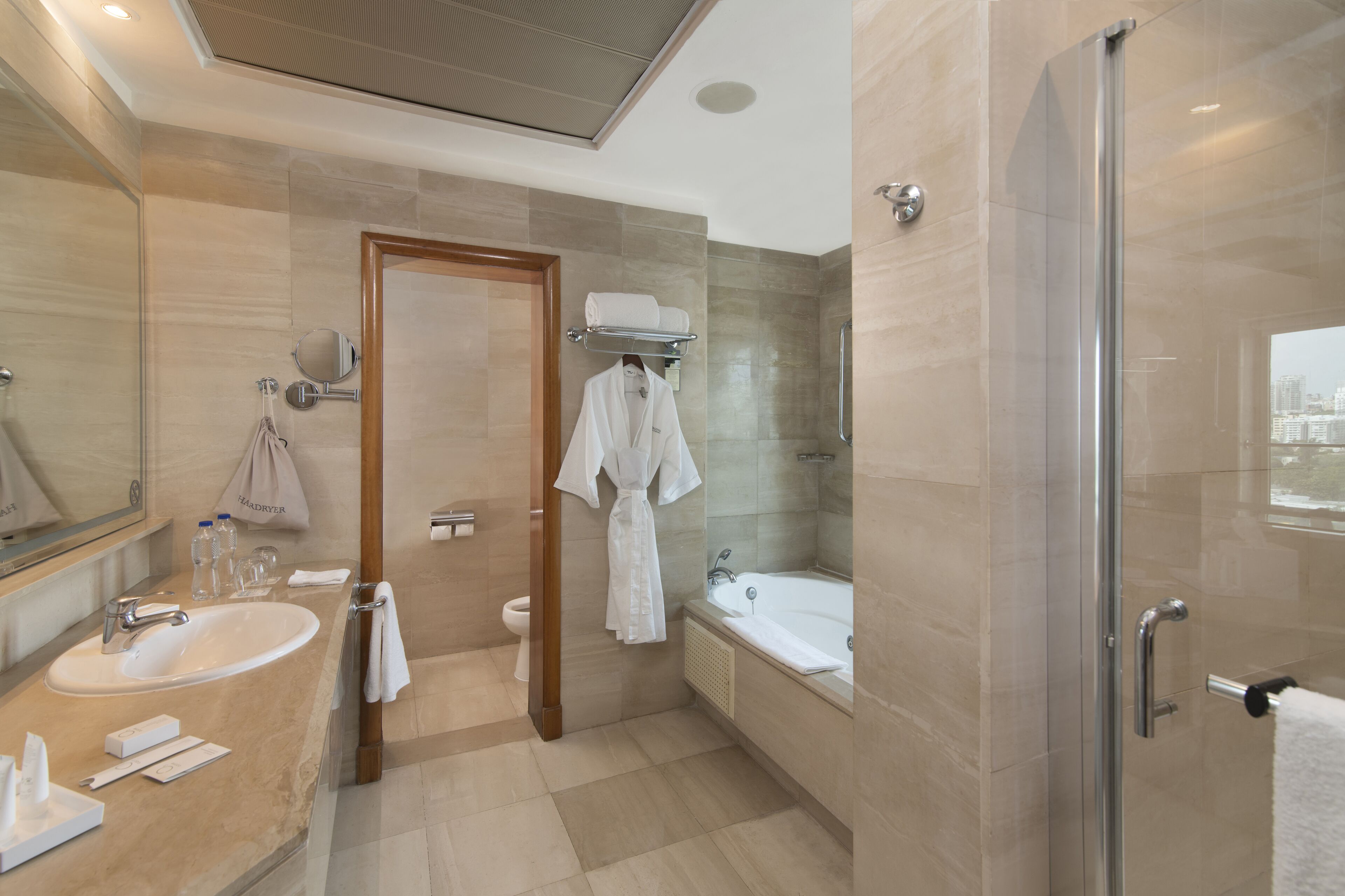 A modern bathroom with a sink, mirror, and a glass-enclosed shower area.