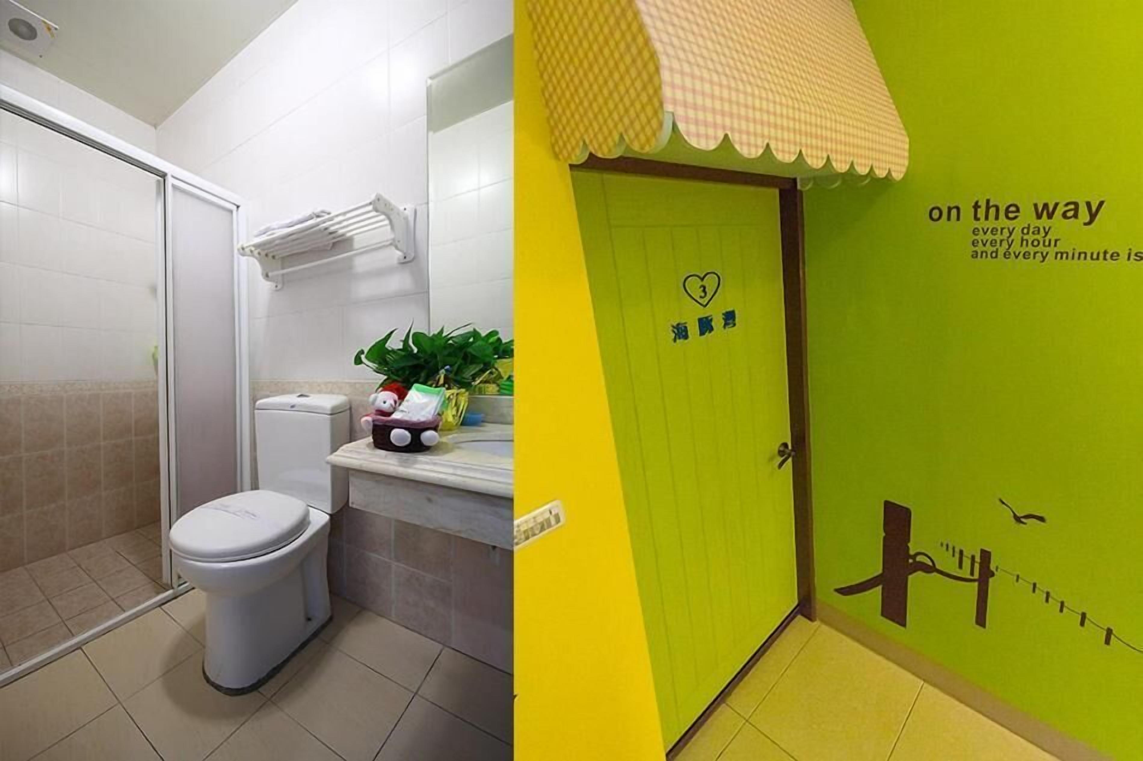 A bathroom with a toilet, shower, and a towel rack.